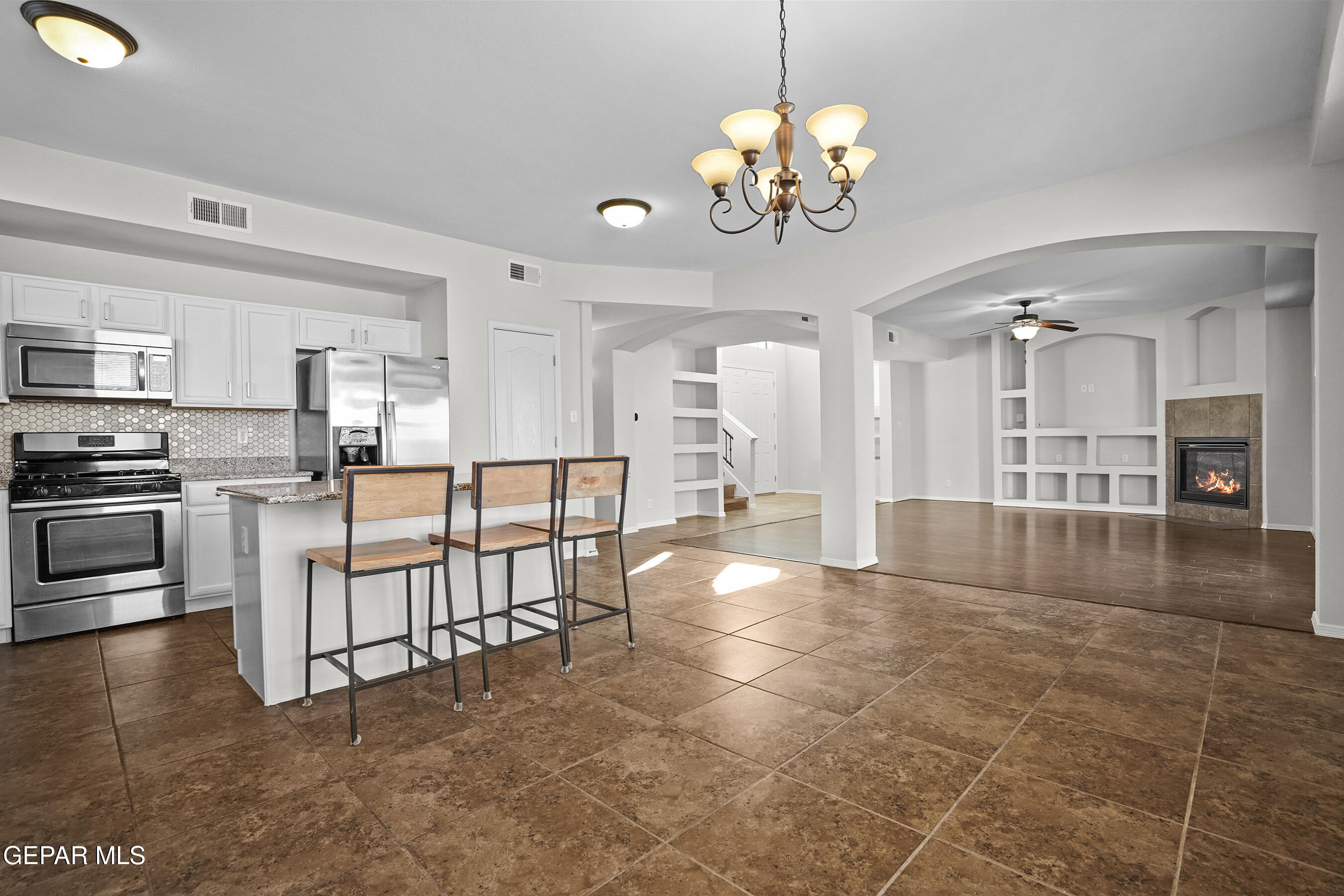 11265 Cattle Ranch Street El Paso, TX 79934 - Photo 10 of 44 a view of a kitchen and dining area a chandelier