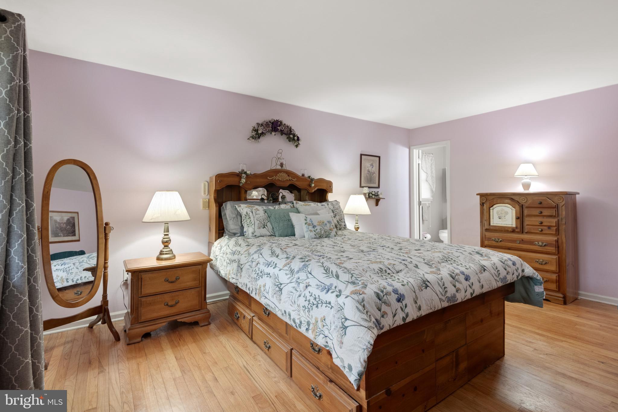 685 Chambers Rock Road Landenberg, PA 19350 - Photo 30 of 49 a bedroom with a bed and a dresser with wooden floor
