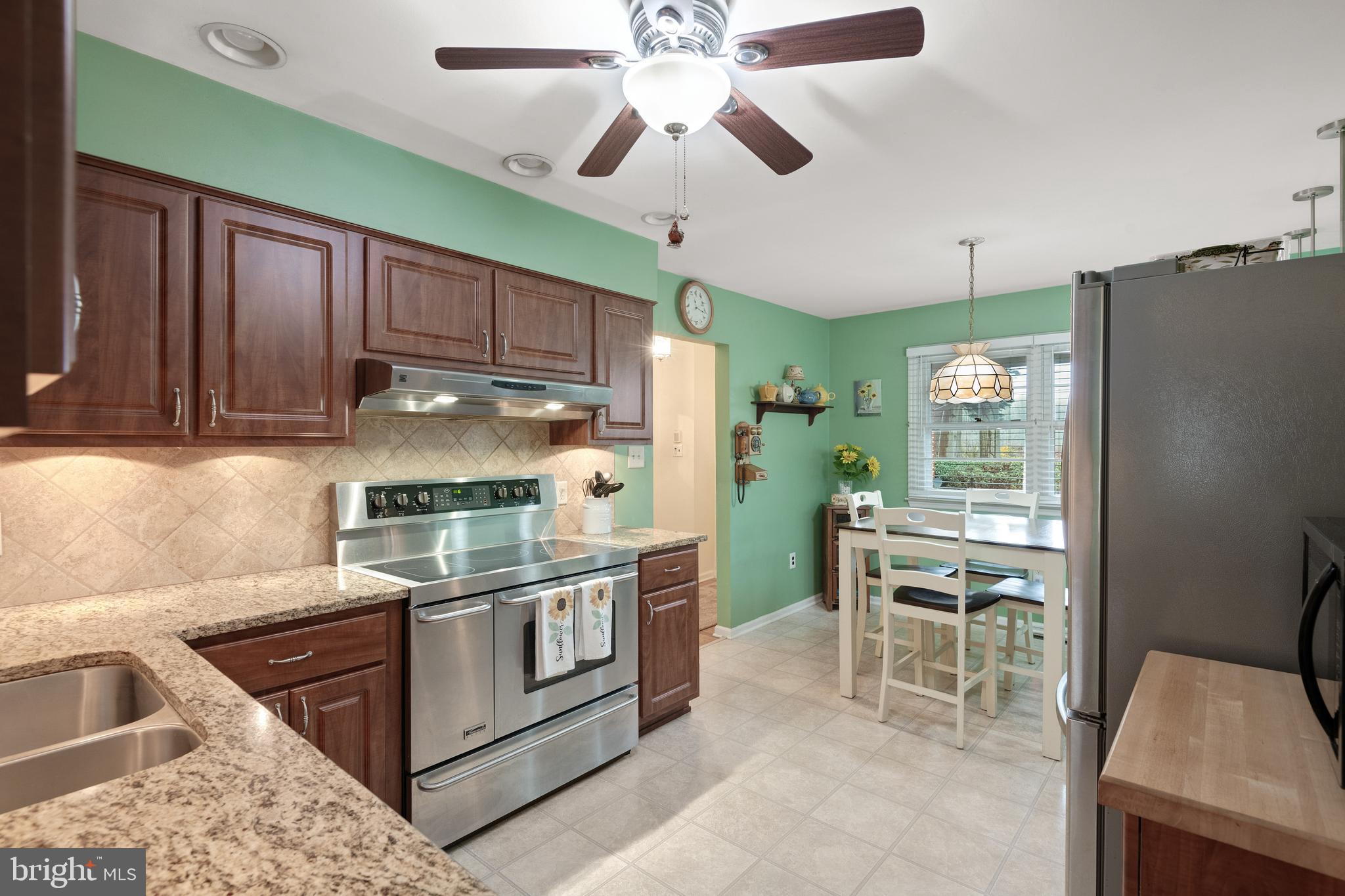 685 Chambers Rock Road Landenberg, PA 19350 - Photo 5 of 49 a kitchen with stainless steel appliances granite countertop a stove refrigerator and cabinets