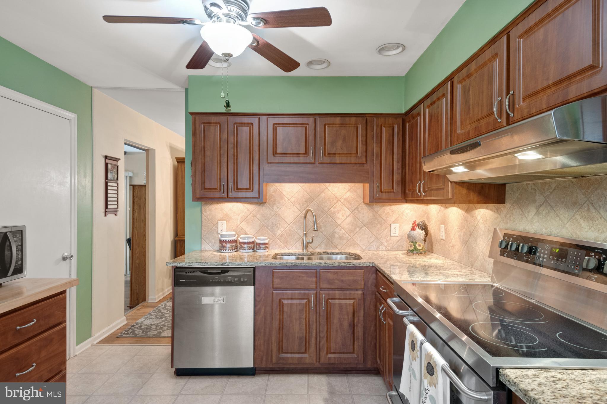 685 Chambers Rock Road Landenberg, PA 19350 - Photo 7 of 49 a kitchen with stainless steel appliances granite countertop a sink a stove and a refrigerator