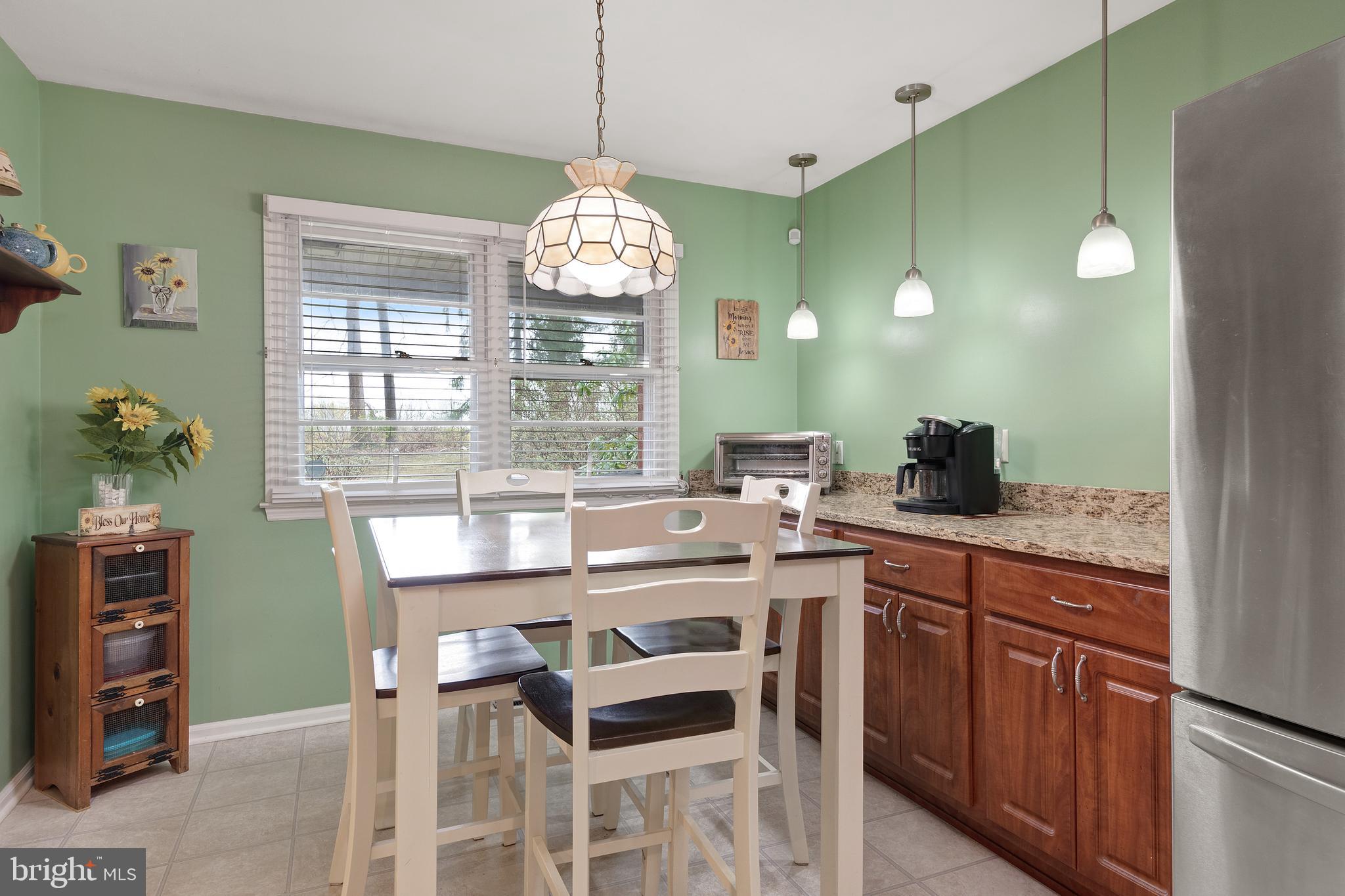 685 Chambers Rock Road Landenberg, PA 19350 - Photo 8 of 49 a kitchen with cabinets a counter space dining table and a chandelier