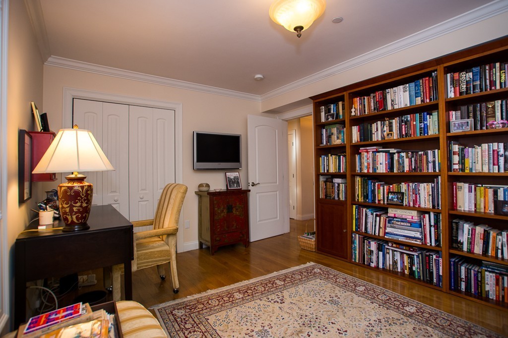69 Parkton Road, Unit 1 Boston, MA 02130 - Photo 12 of 30 a workspace with furniture and a book shelf
