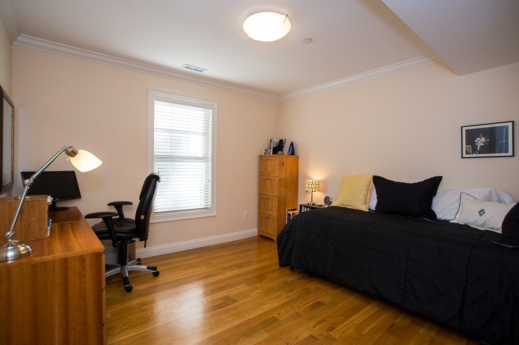 69 Parkton Road, Unit 1 Boston, MA 02130 - Photo 13 of 30 a bed room with a bed furniture and a window