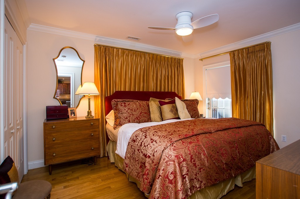 69 Parkton Road, Unit 1 Boston, MA 02130 - Photo 15 of 30 a bedroom with a bed and a chandelier