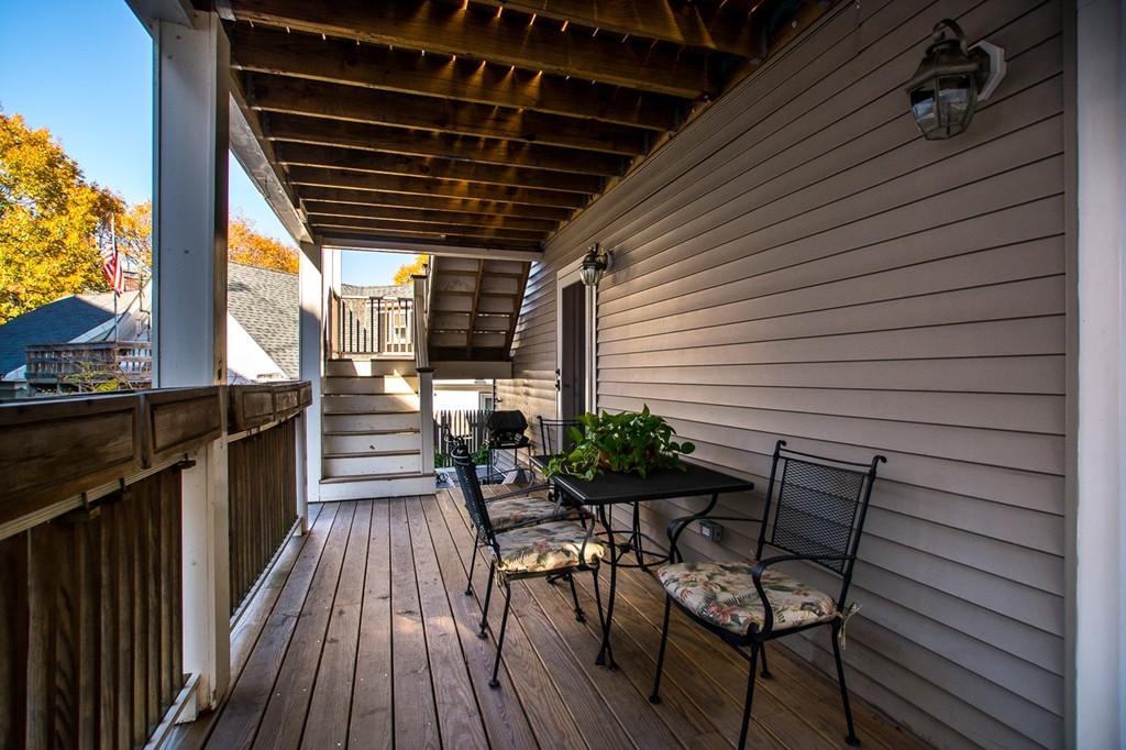 69 Parkton Road, Unit 1 Boston, MA 02130 - Photo 18 of 30 a patio with wooden floor and outdoor seating