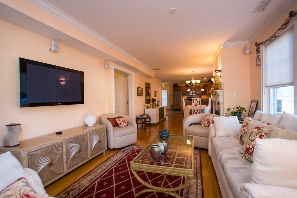 69 Parkton Road, Unit 1 Boston, MA 02130 - Photo 3 of 30 a living room with furniture and a flat screen tv