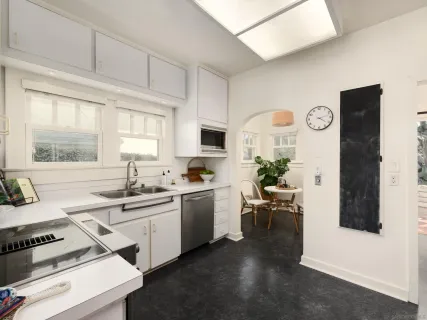 a kitchen with a sink stove and cabinets
