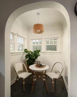 a view of a dining room with furniture and window