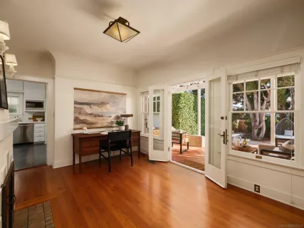 a view of a livingroom with furniture hardwood floor and a view of kitchen