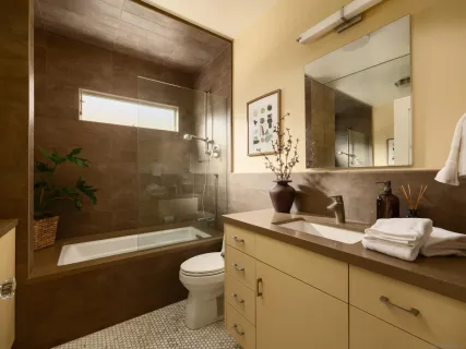 a bathroom with a sink a toilet and shower