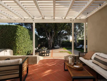 a view of a patio with couches chairs and potted plants