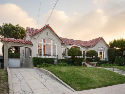 a front view of a house with a garden