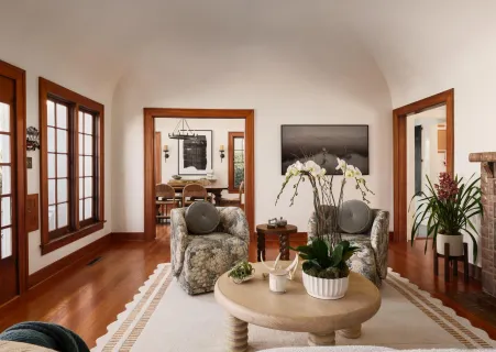 a living room with furniture and wooden floor