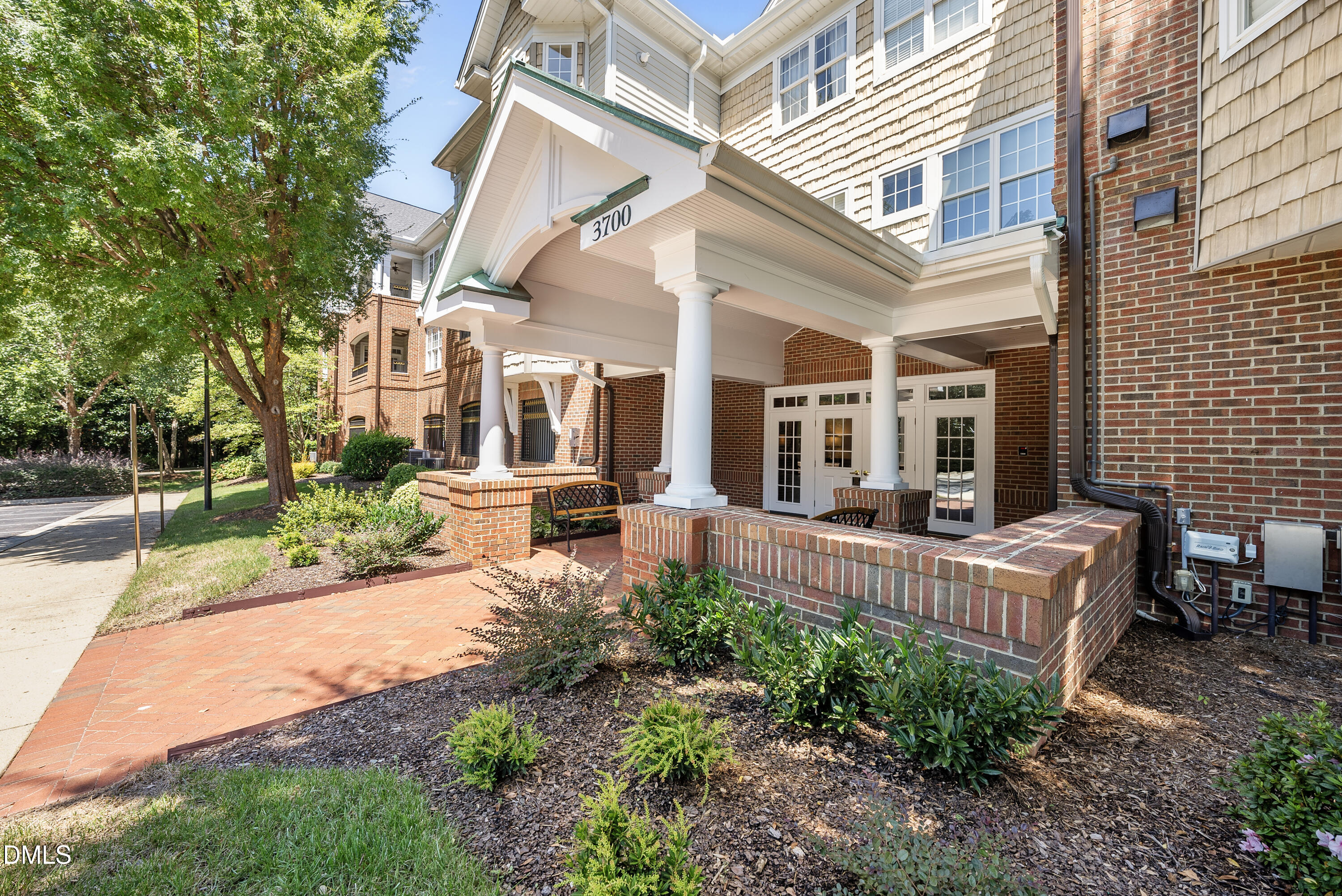 a view of a house with backyard and sitting area