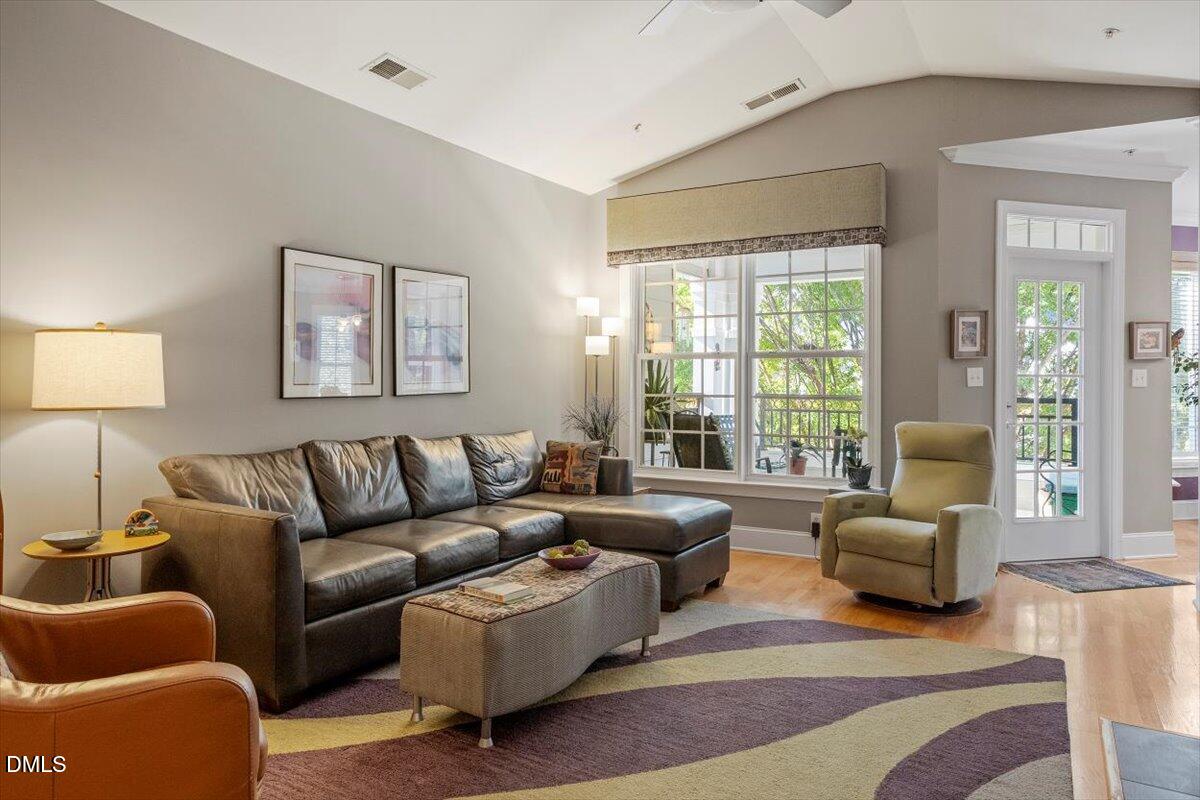 3700 Baron Cooper Pass, Unit 204 Raleigh, NC 27612 - Photo 10 of 39 a living room with furniture a large window and a lamp
