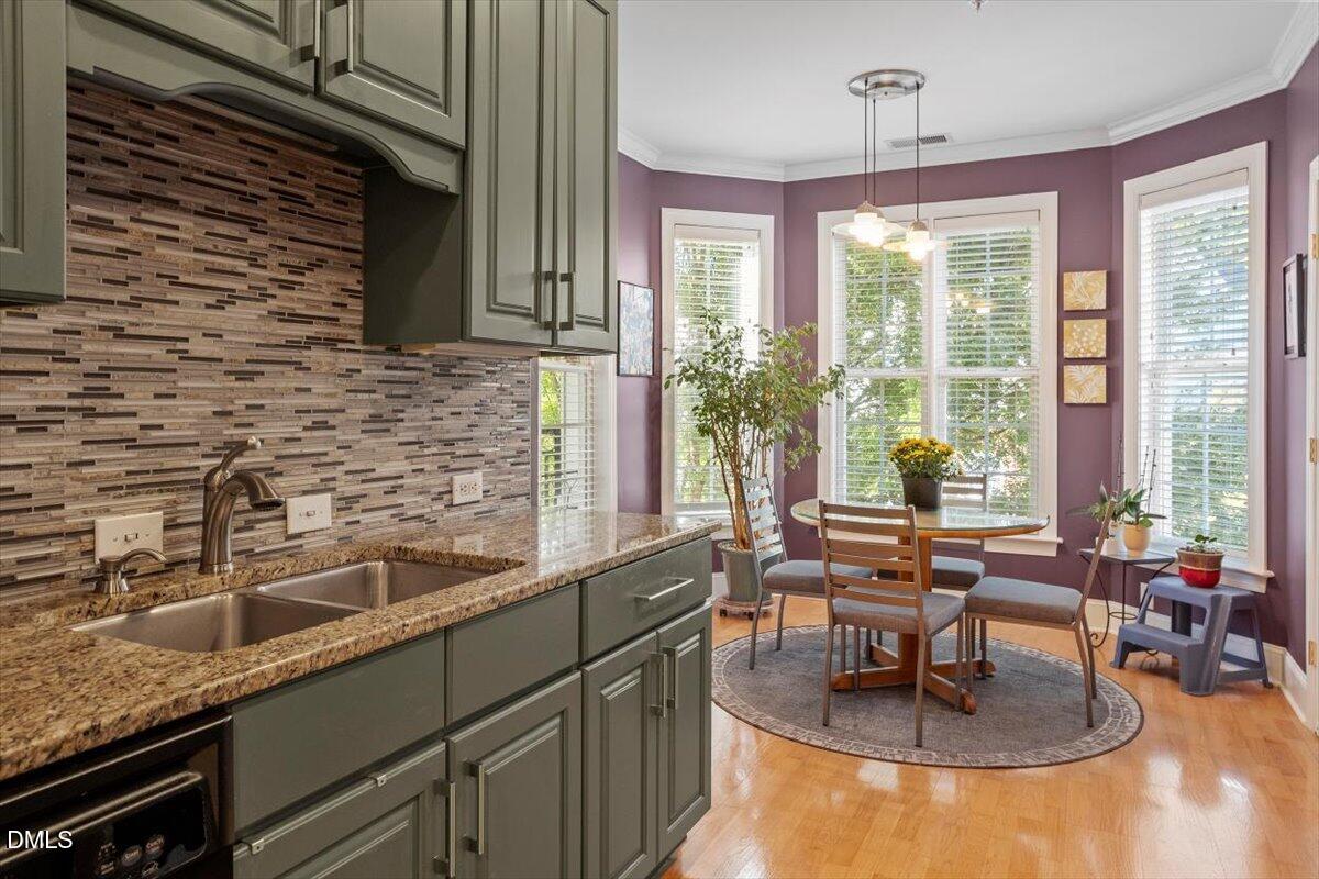 3700 Baron Cooper Pass, Unit 204 Raleigh, NC 27612 - Photo 17 of 39 a kitchen with a sink and large windows