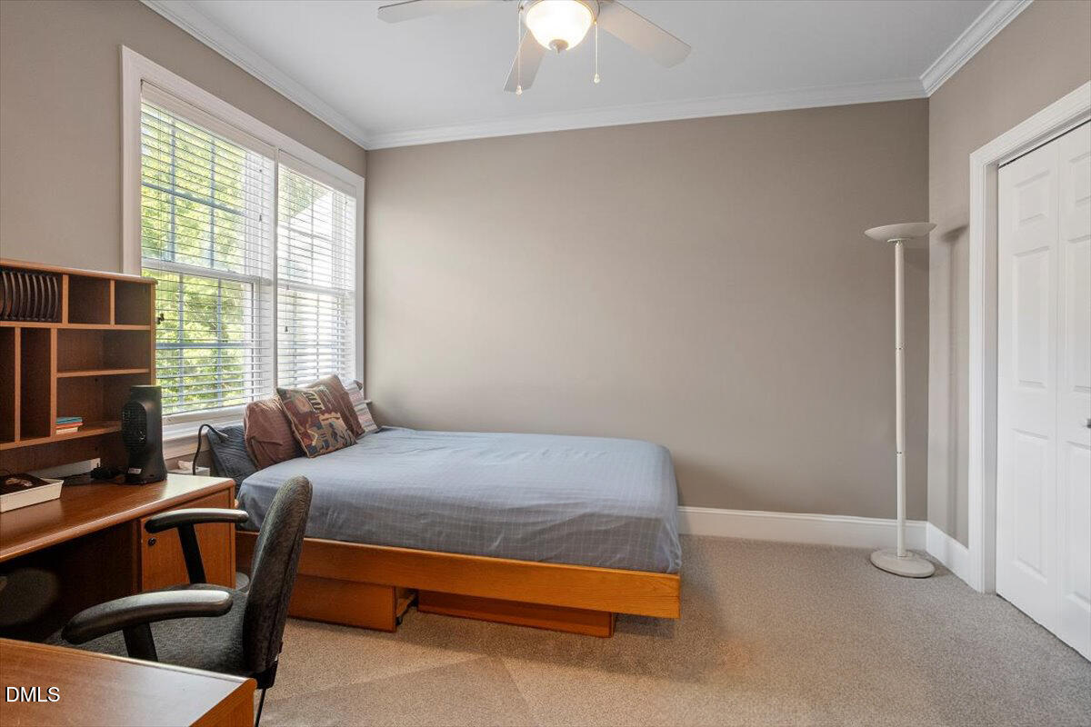3700 Baron Cooper Pass, Unit 204 Raleigh, NC 27612 - Photo 20 of 39 a bedroom with a bed a chandelier and a window