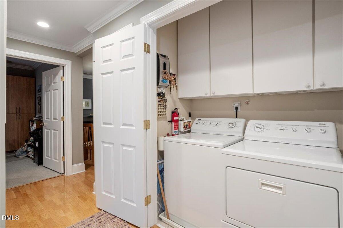 3700 Baron Cooper Pass, Unit 204 Raleigh, NC 27612 - Photo 21 of 39 a view of storage and utility room with washer and dryer