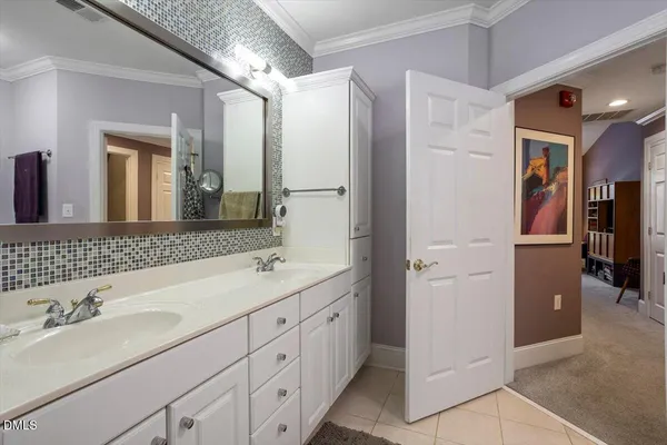a bathroom with a double vanity sink and mirror