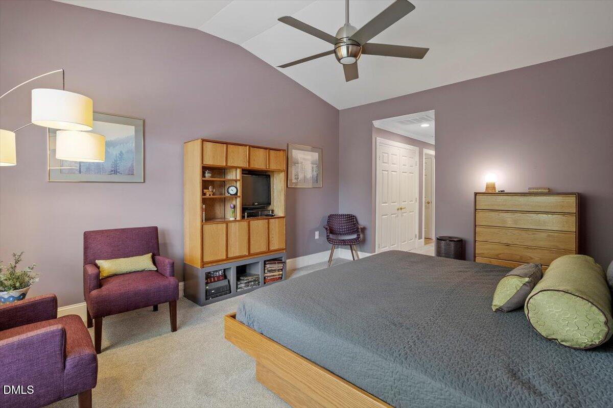 3700 Baron Cooper Pass, Unit 204 Raleigh, NC 27612 - Photo 28 of 39 a bedroom with a bed and wooden floor