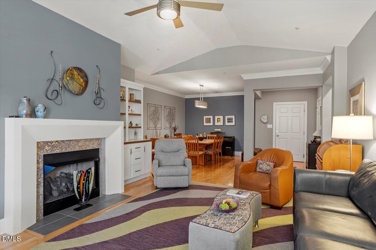 3700 Baron Cooper Pass, Unit 204 Raleigh, NC 27612 - Photo 3 of 39 a living room with furniture and a fireplace