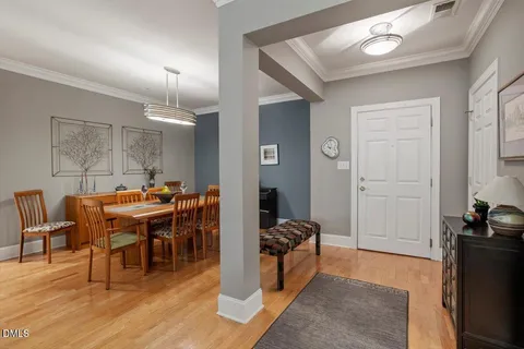 a living room with furniture and a dining table