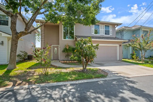 a front view of a house with garden