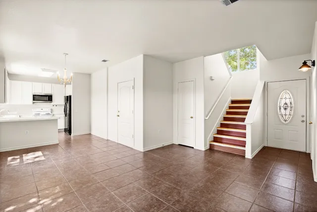 a view of kitchen and hallway with stairs