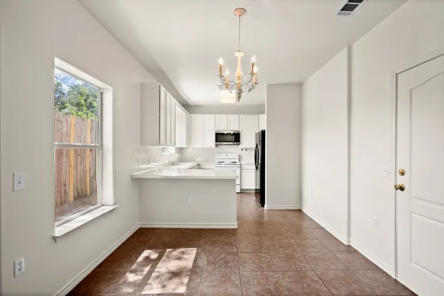 a view of a kitchen sink and dishwasher with wooden floor