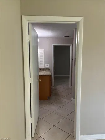 a view of a bathroom from a corridor