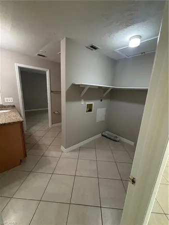 a view of a utility room and empty room