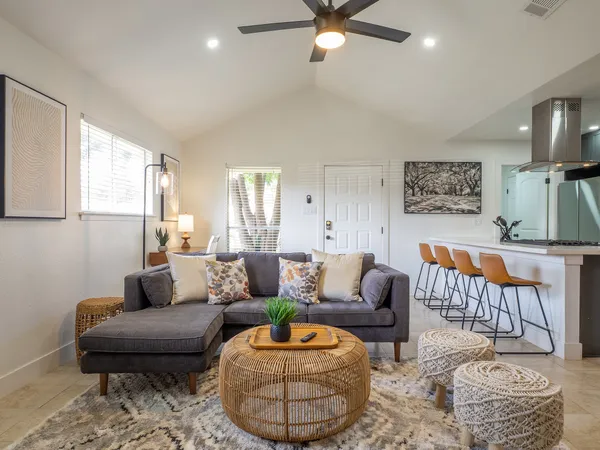 a living room with furniture and a rug
