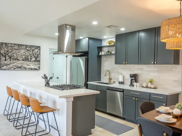 a kitchen with stainless steel appliances kitchen island granite countertop a sink and cabinets
