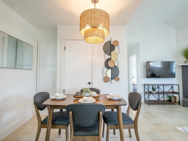 a dining room with furniture and a flat screen tv