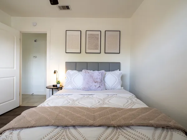 a bedroom with a large bed and a window