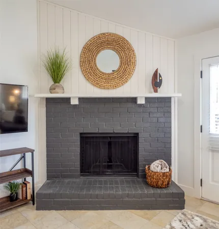 a living room with a fireplace and a flat screen tv