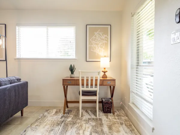 a view of a dining room with furniture and a window
