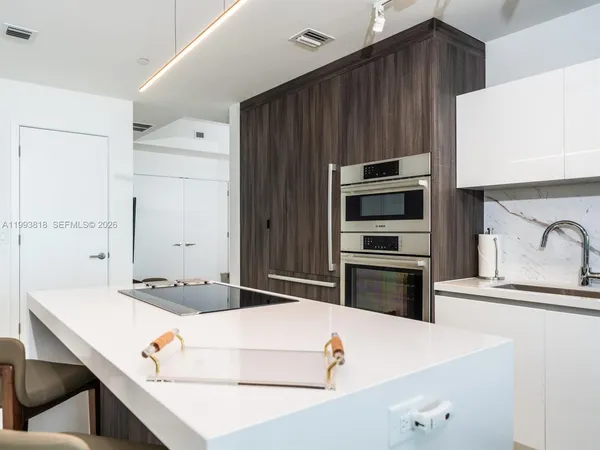 a kitchen with a stove and a refrigerator