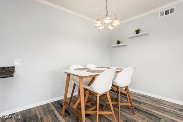 a view of a dining room with furniture and chandelier