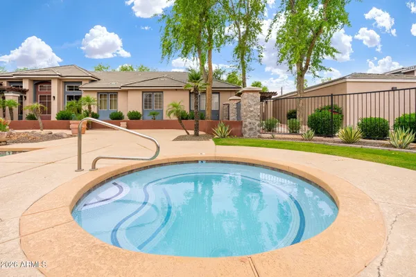 a view of a house with swimming pool and sitting area