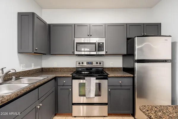 a kitchen with a sink stove and refrigerator