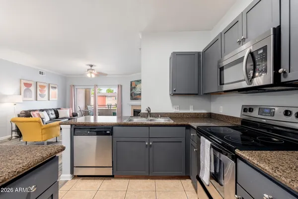 a kitchen with stainless steel appliances granite countertop a sink and stove top oven