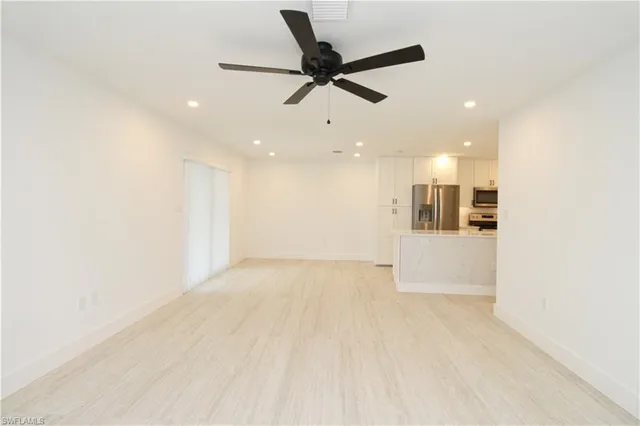a view of a kitchen with a sink and a refrigerator