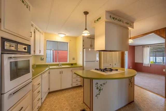 a kitchen with stainless steel appliances a stove a sink and a refrigerator