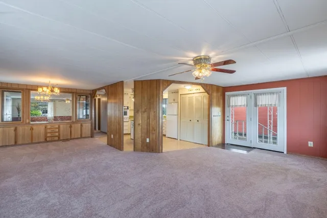 a view of a livingroom with a ceiling fan and window