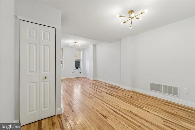 a view of an empty room with wooden floor
