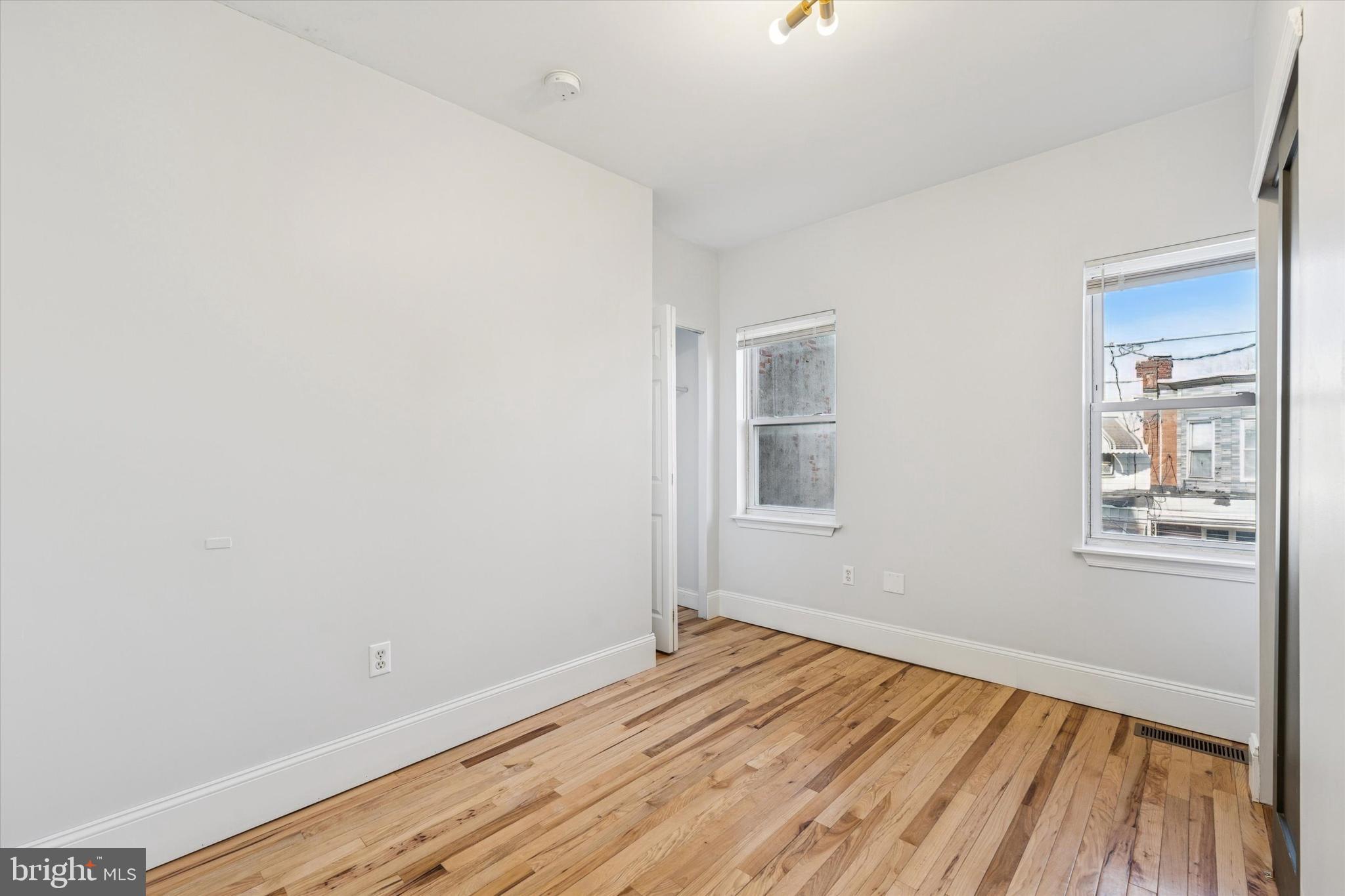2814 West Stiles Street Philadelphia, PA 19121 - Photo 20 of 34 an empty room with wooden floor and windows