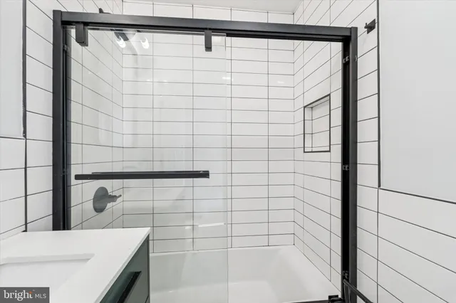 a bathroom with a shower and a sink