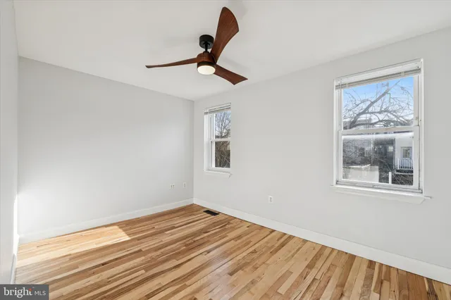a view of room with window and wooden floor