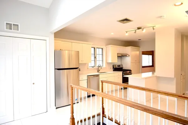 a view of a living room with a kitchen